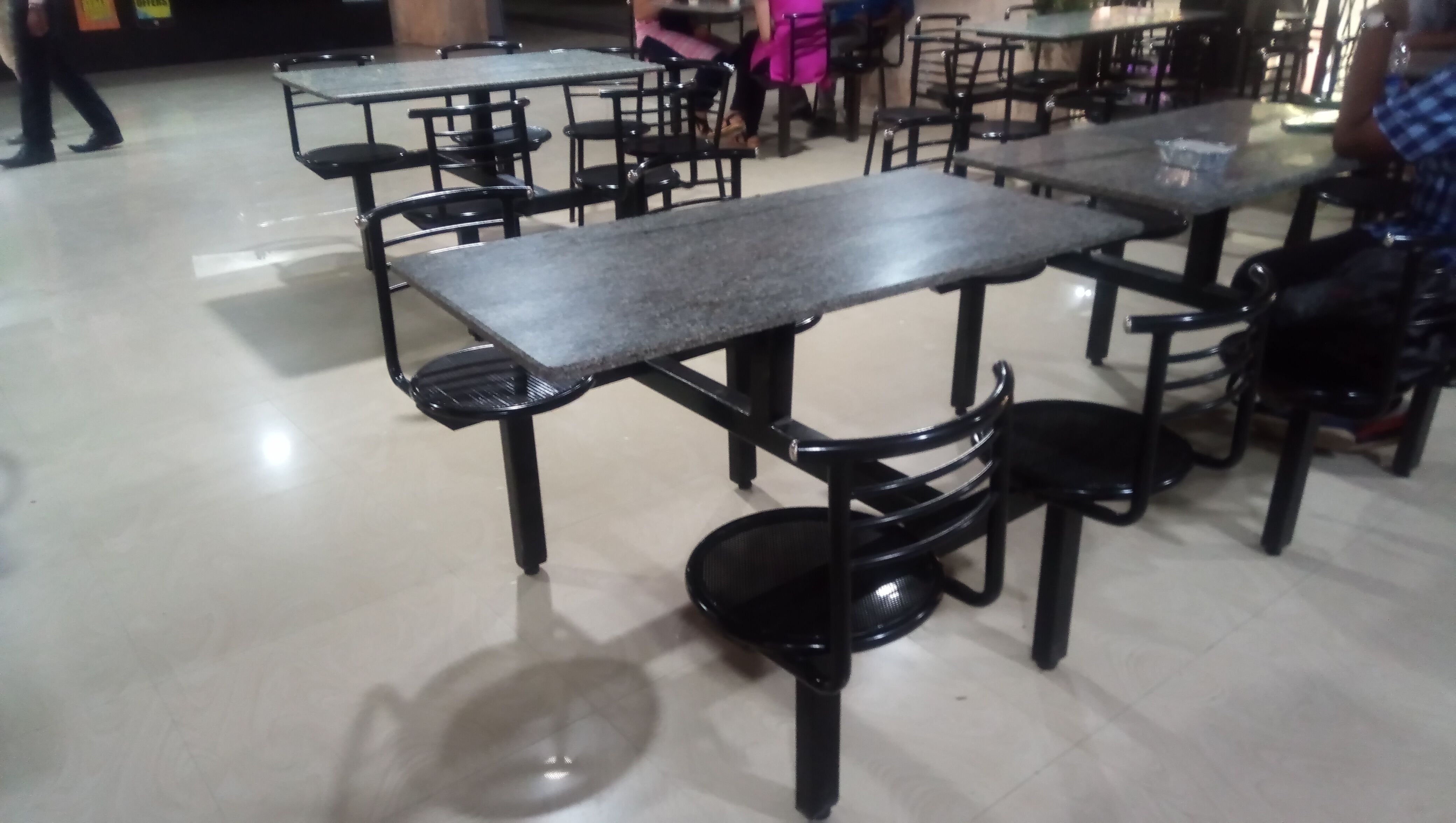 Cafe table mounted metal chairs
